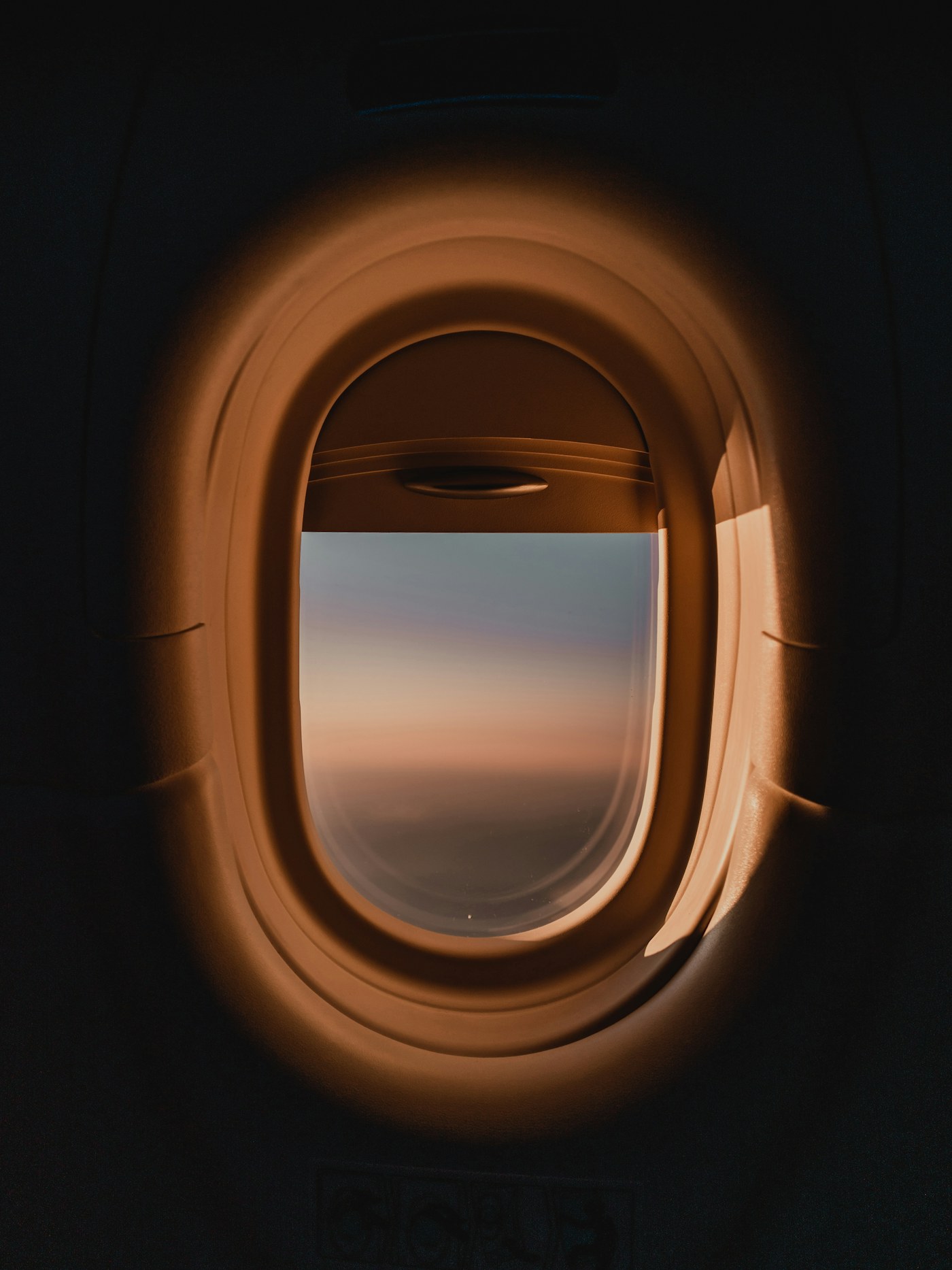 Golden sunset seen through an aircraft window